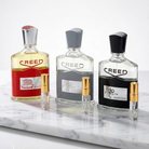Three Creed fragrance decants: Viking, Aventus Cologne, and Aventus, with two smaller sample vials.